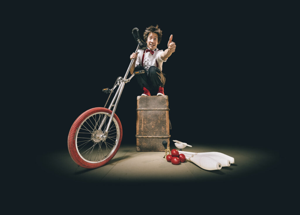 A Man in a case with a unicycle